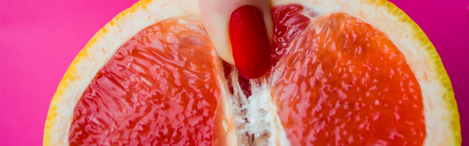 Woman's finger on sliced orange