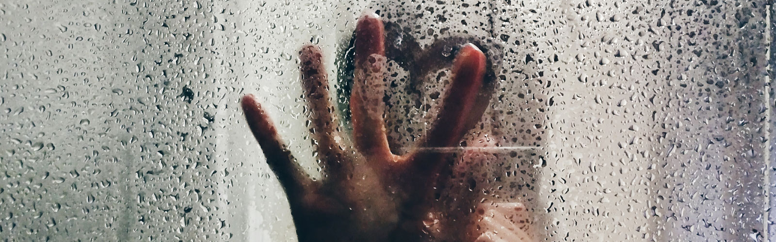 Couple's hands on shower screen