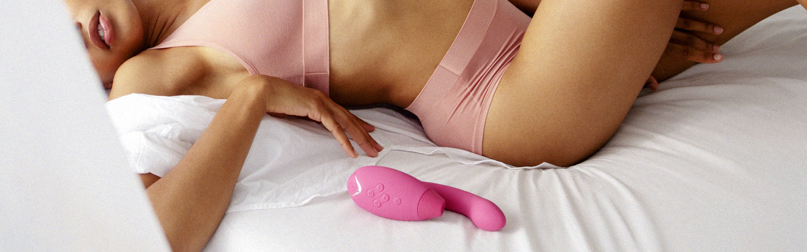 Woman on bed with vibrator