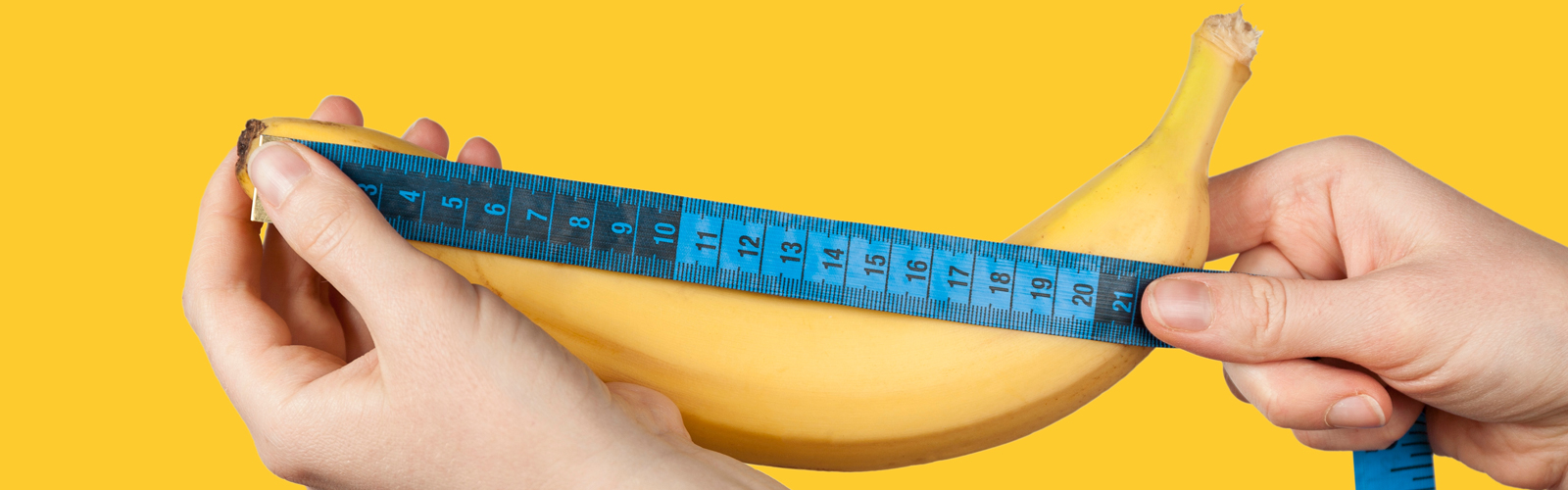 Person measuring a banana