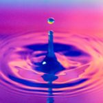 A water dropplet with a pink background