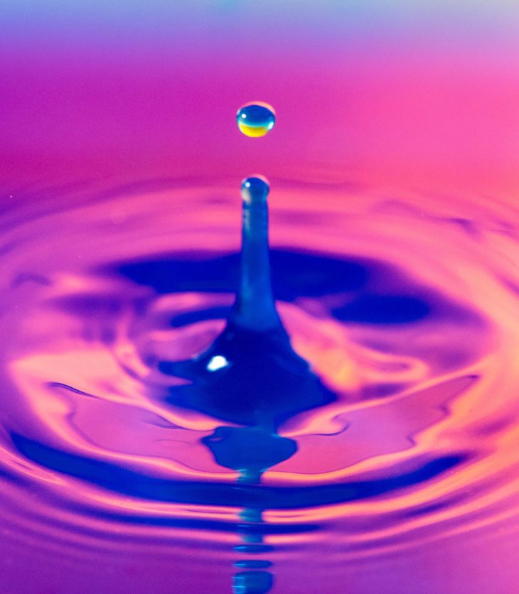 A water dropplet with a pink background