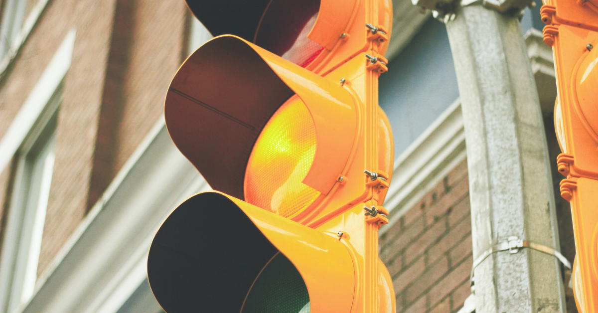 Set of traffic lights with orange light lit up