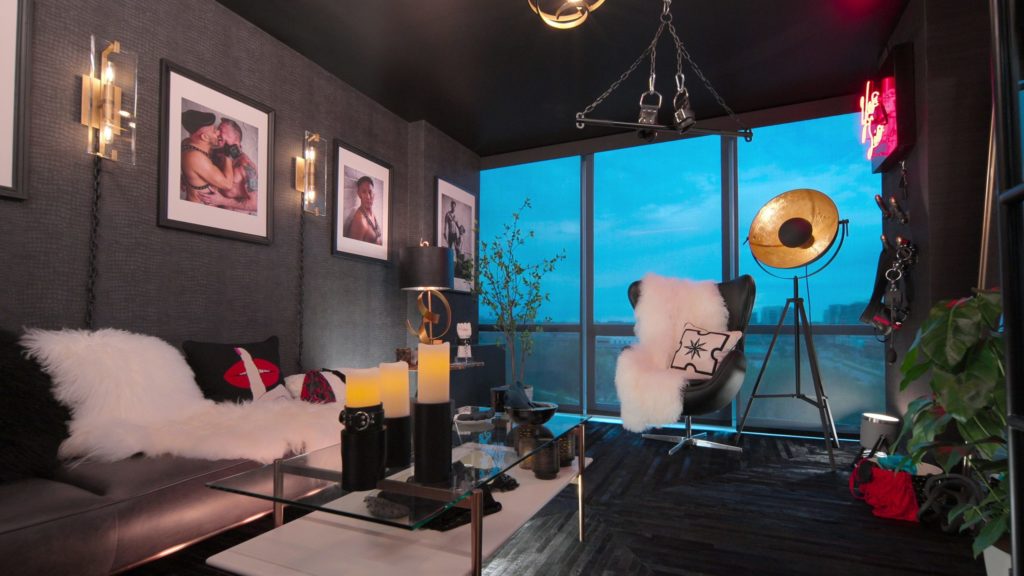 Black Leather Den with glass table, textured throws and erotic photography