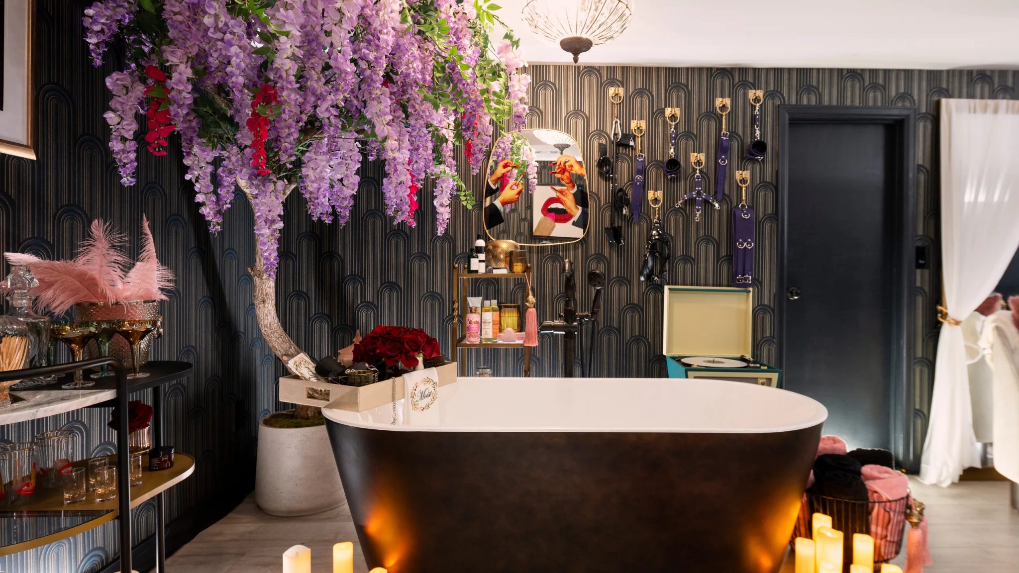 luxury glamour space with textured wallpaper, full bathtub and greenery