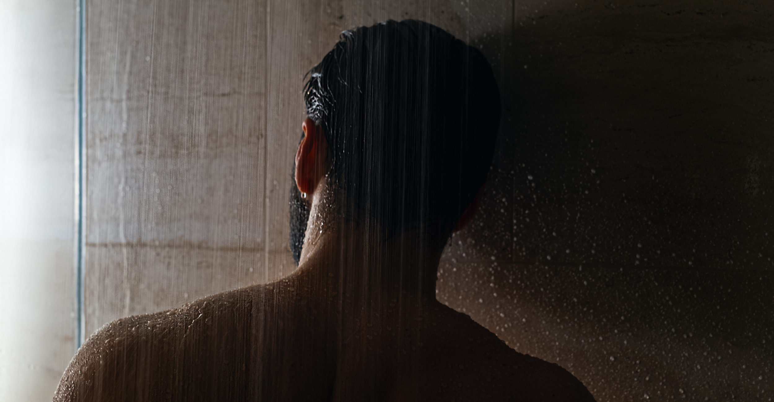 Man in the shower facing away