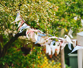 Colourful bunting flutters in a backyard breeze