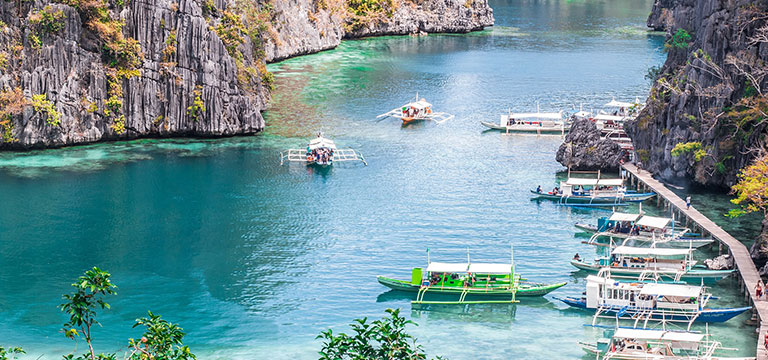 A view of many small boats used for island hopping in Palawan, Philippines. Sometimes the less travelled places make for the best romantic escapes.