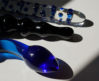 Expensive Glass Dildos on a sunlit table