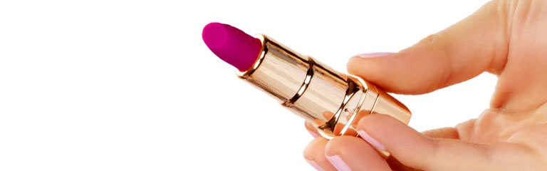 A lipstick shaped mini vibrator held in a woman