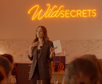 Melissa Vranjes holds up the BJ Like a Boss pleasure guide during her workshop at Wild Secrets HQ